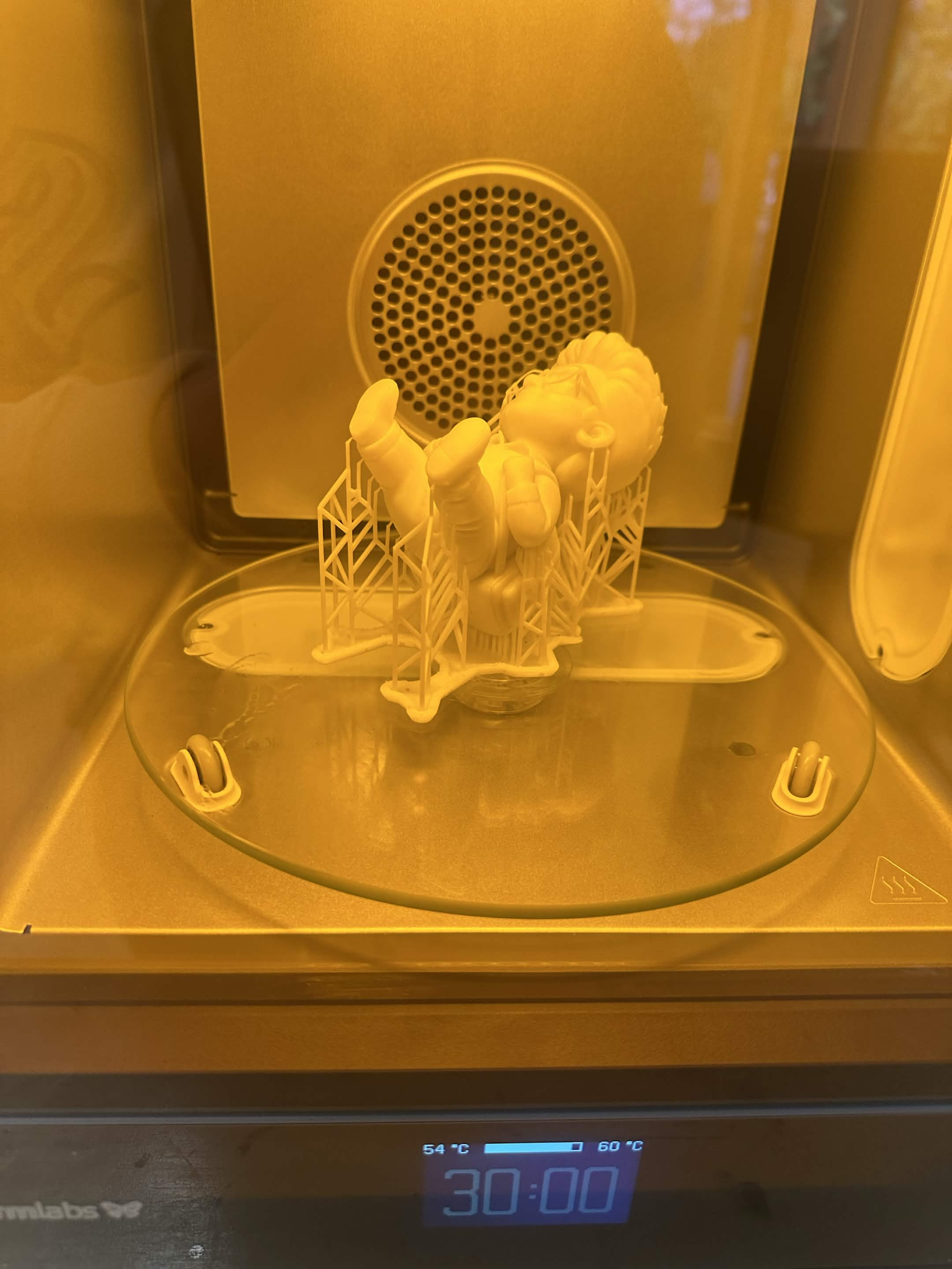 The print curing under UV light in a Formlabs curing station